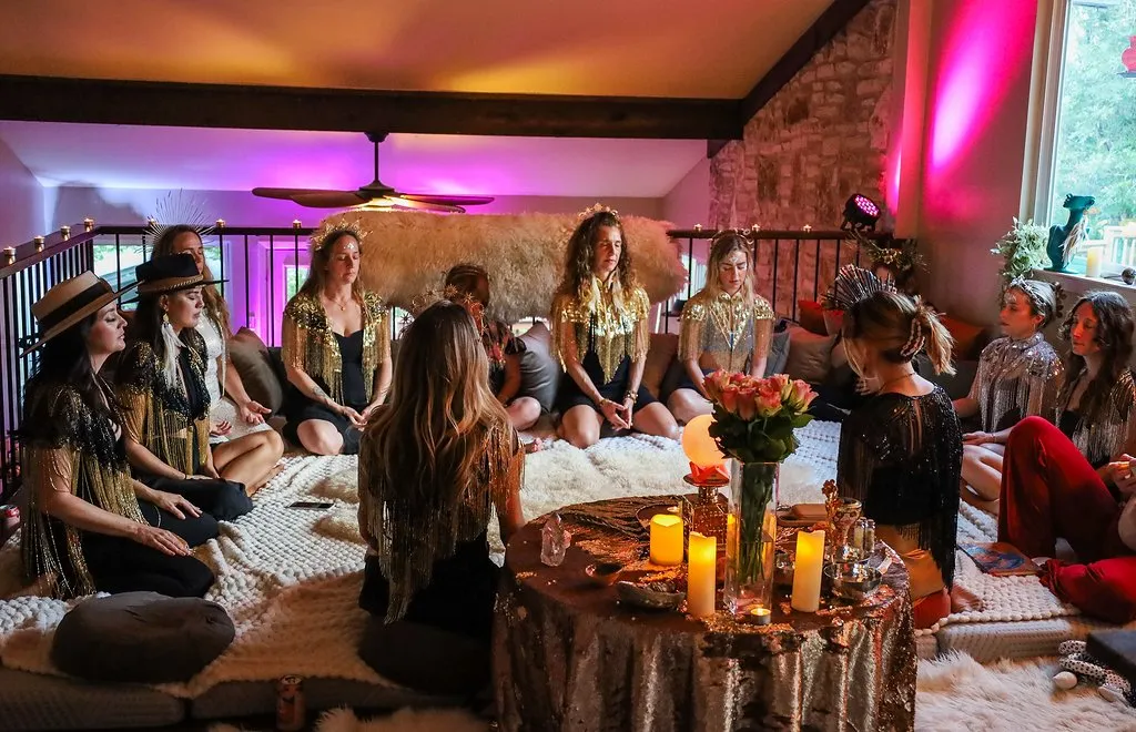 Women gathered in a circle around a candlelit altar